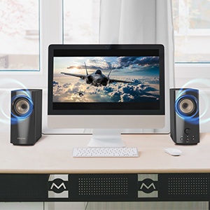 creative t60 beside a pc monitor showing a movie scene with powerful audio effects