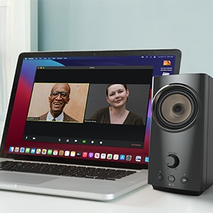 creative t60 beside a laptop with conference call going on