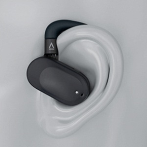 Black and white wireless earbud shown fitted in a model ear, featuring a compact ergonomic design.