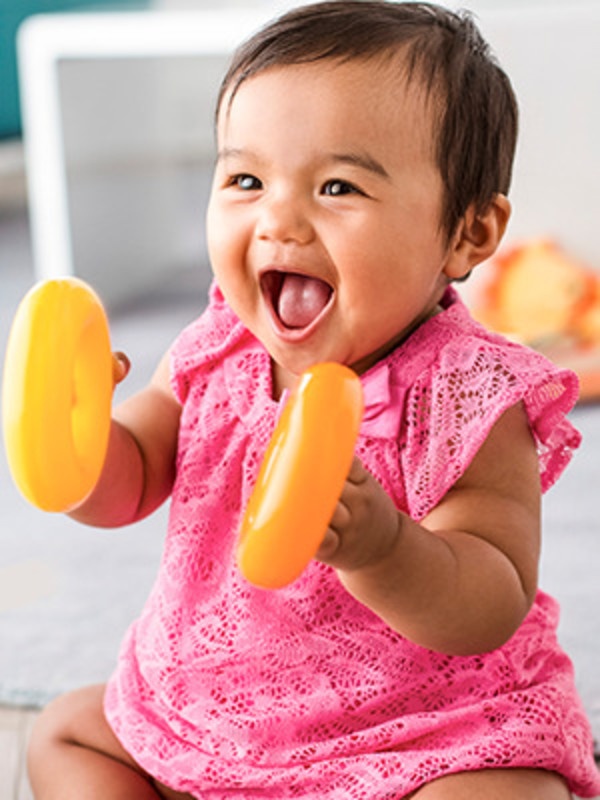 A sequence showing a baby interacting with brightly colored objects or toys against a white background.