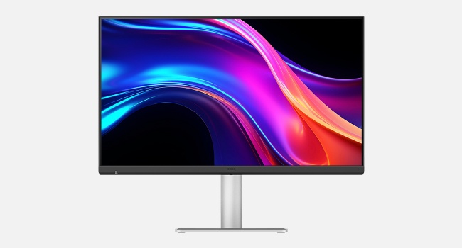Modern computer monitor or display with sleek white stand, showing vibrant blue and pink abstract wave patterns against a dark background.