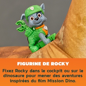 Le texte indique « FIGURINE DE ROCKY » et « Filez Rocky dans le cockpit ou sur le dinosaure pour mener des aventures inspirées du film Mission Dino ». Figurine de personnage animé vert affichée à côté d'un élément de dinosaure brun.